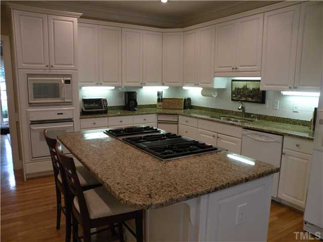 313 Carpathian Way Raleigh, NC 27615 - Photo 8 of 25 The chef of the home will love this kitchen. The center island with gas cook top is a wonderful convenience. Recently upgraded granite counter tops. Kitchen