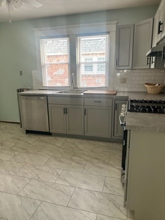 63 Merrimac Avenue Springfield, MA 01104 - Photo 11 of 22 a kitchen with a stove a sink and a window
