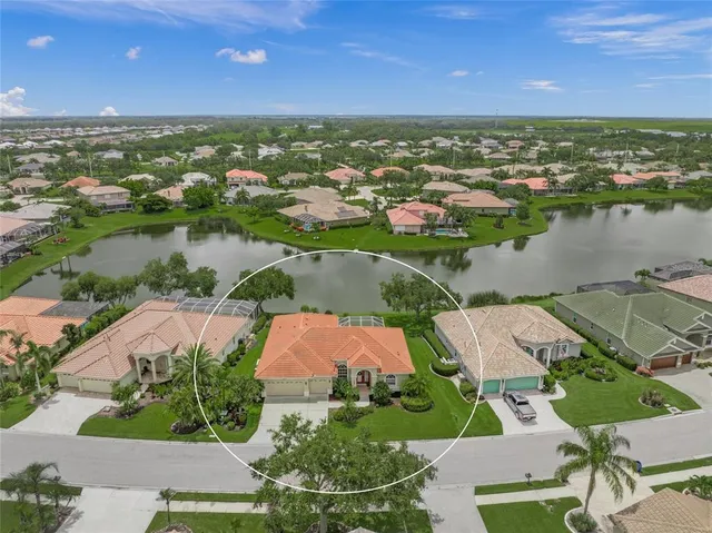 an aerial view of residential houses with outdoor space and river