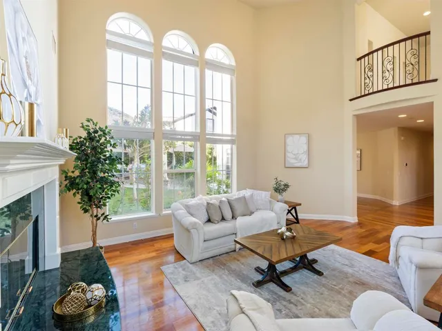 a living room with furniture fireplace and a large window