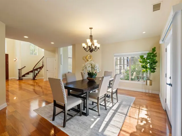 a view of a dining room with furniture window and wooden floor