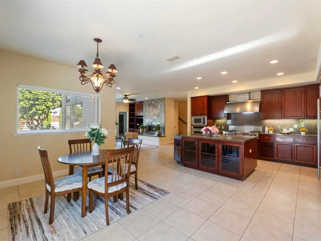 a kitchen with stainless steel appliances granite countertop a stove and a refrigerator