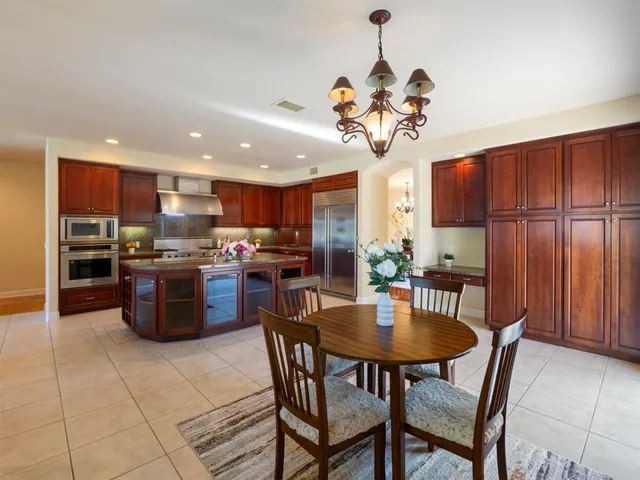 a kitchen with granite countertop a sink stainless steel appliances and cabinets