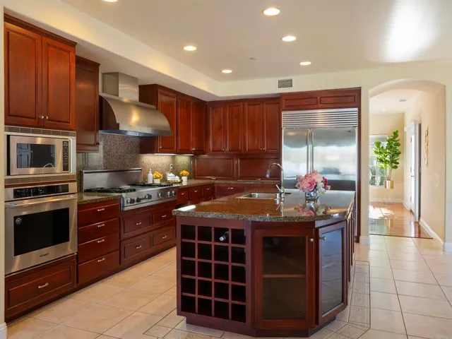 a living room with furniture potted plant floor to ceiling window