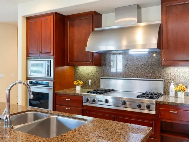 a living room with furniture ceiling fan and a large window
