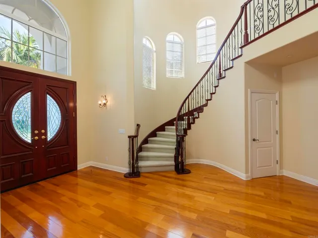 a view of an entryway with wooden floor