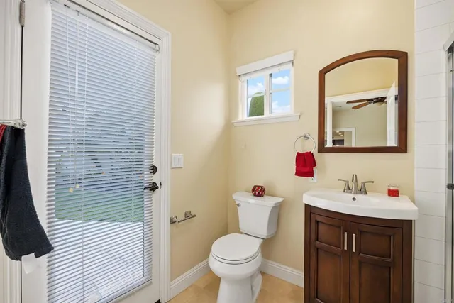 a bathroom with a toilet a sink and a mirror