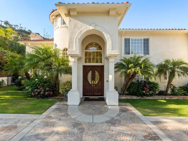a view of a hallway with furniture and floor to ceiling window