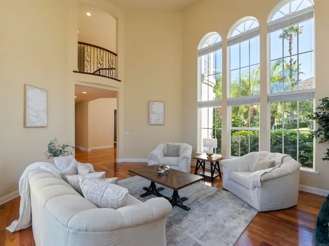 a view of a dining room with furniture and a chandelier