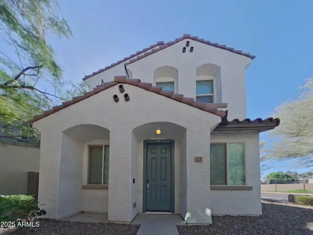a view of a white house with a small yard