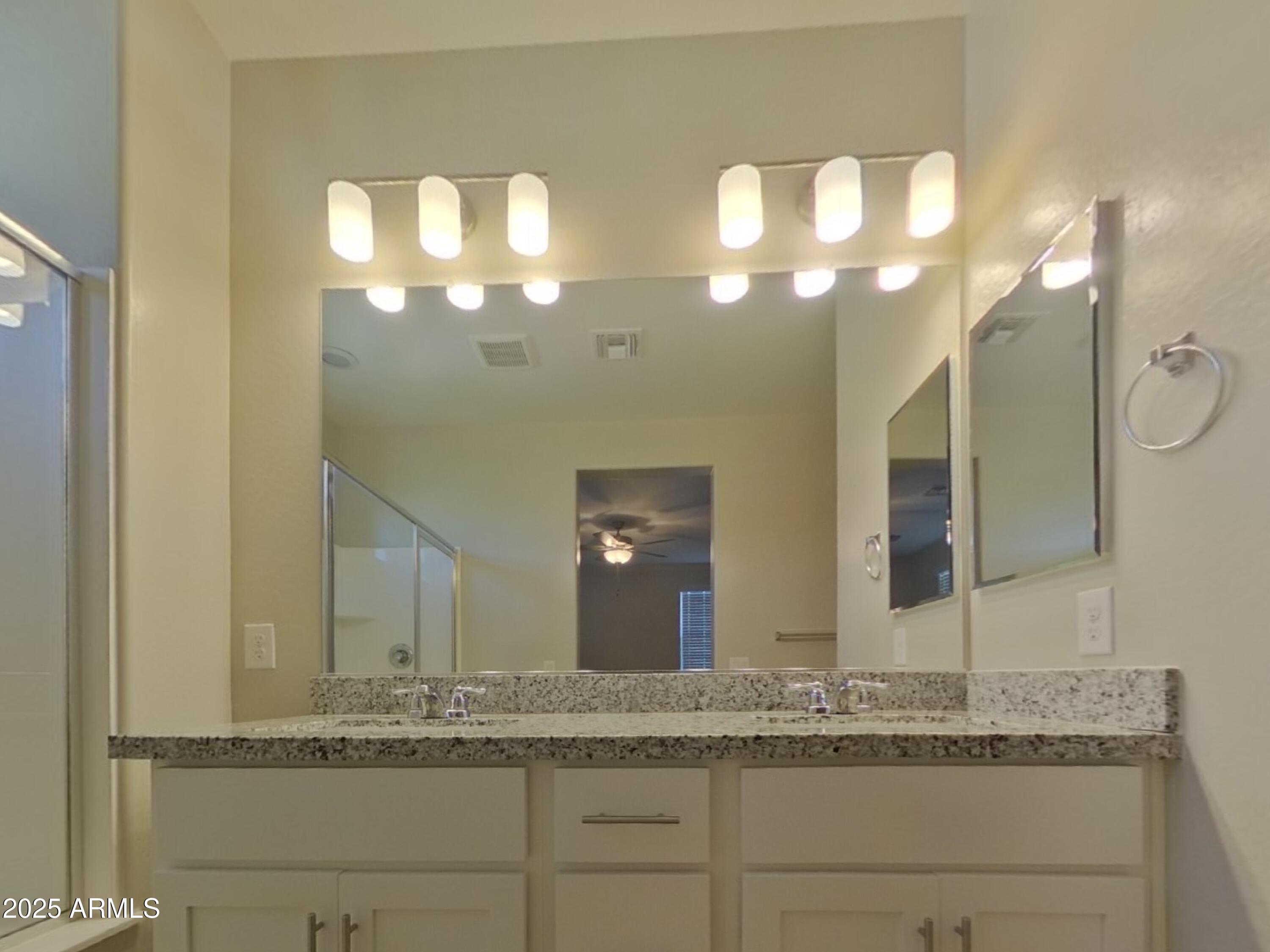 2929 North 28th Street, Unit 13 Phoenix, AZ 85016 - Photo 7 of 16 a bathroom with a granite countertop sink and a mirror