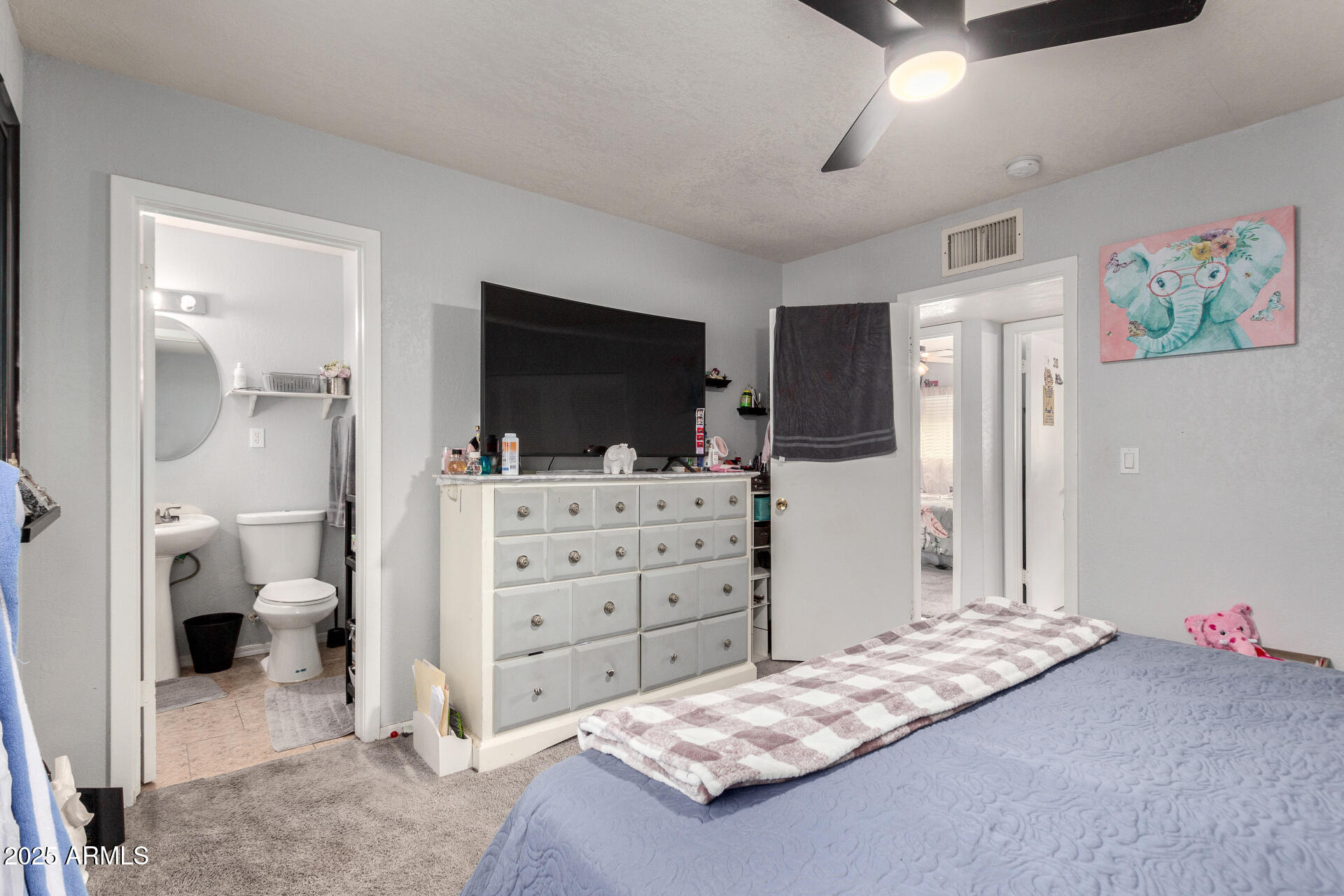 12608 West Lower Buckeye Road Avondale, AZ 85323 - Photo 16 of 26 a bedroom with a bed and a flat screen tv
