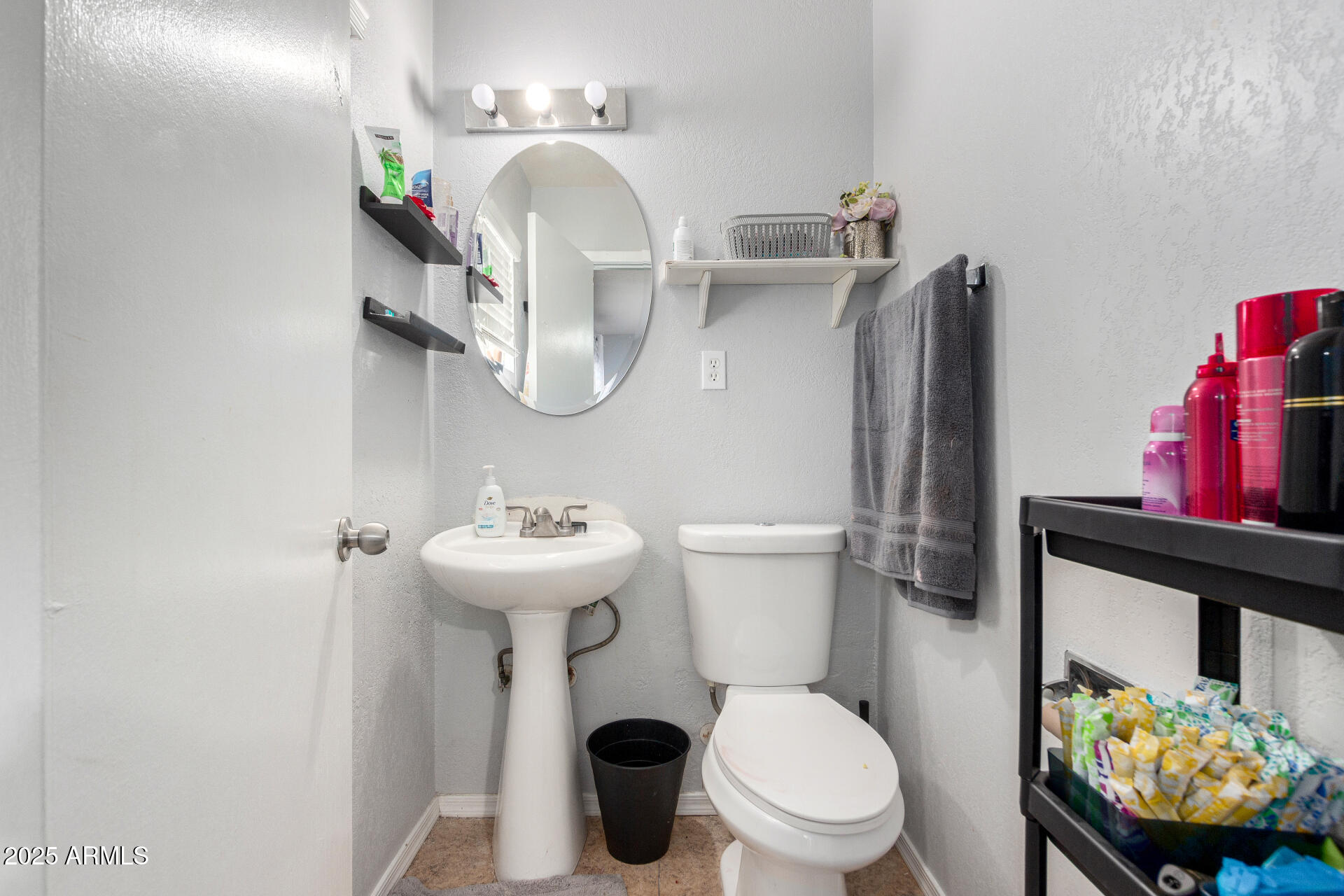 12608 West Lower Buckeye Road Avondale, AZ 85323 - Photo 18 of 26 a bathroom with a sink a toilet and a mirror