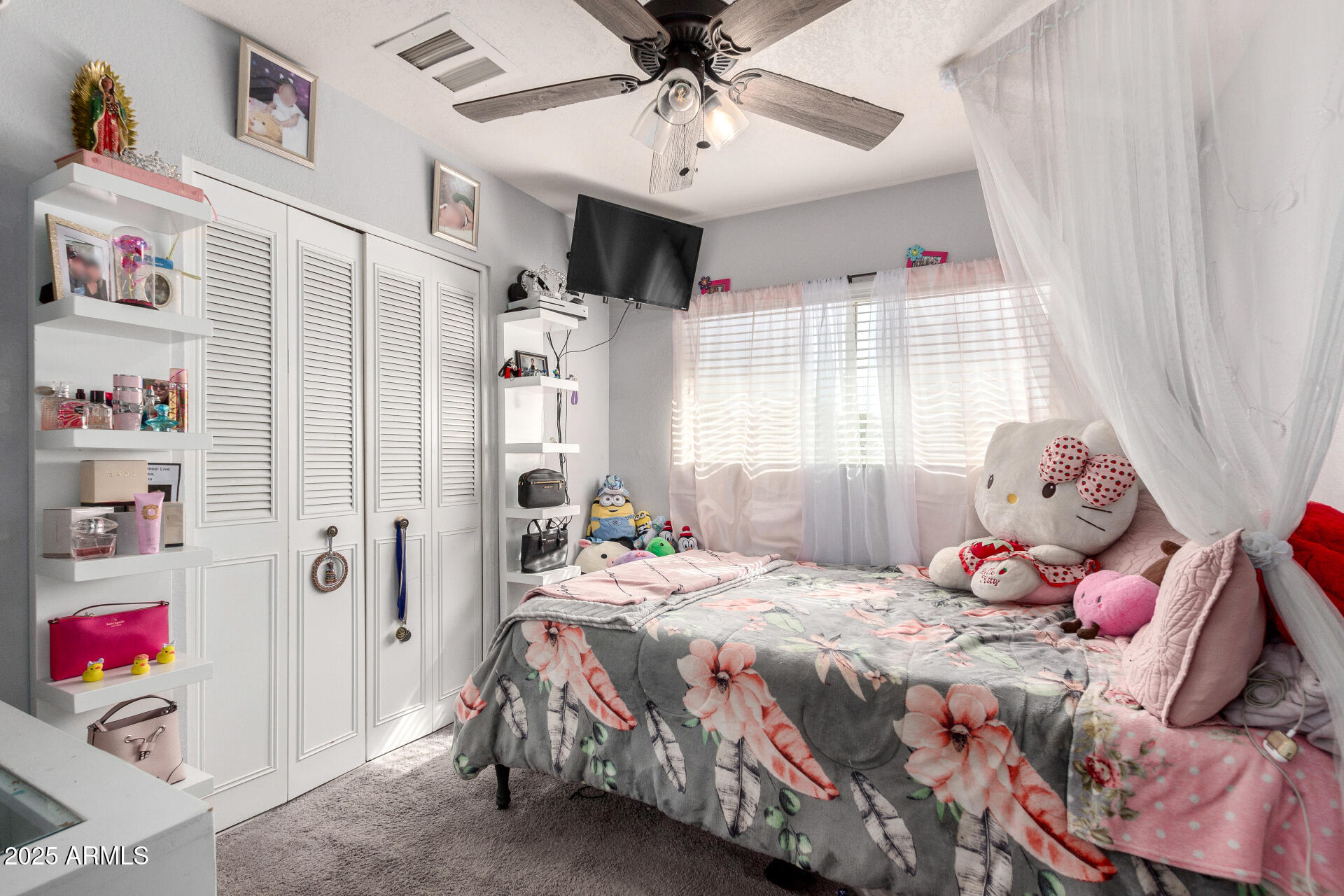 12608 West Lower Buckeye Road Avondale, AZ 85323 - Photo 19 of 26 a bedroom with a bed and a chandelier