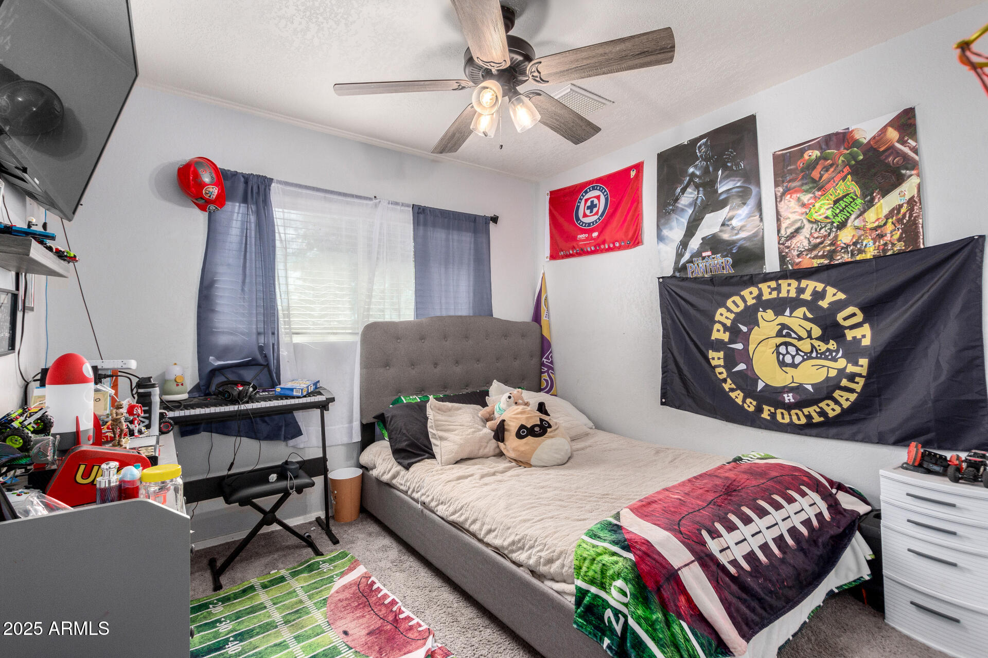 12608 West Lower Buckeye Road Avondale, AZ 85323 - Photo 22 of 26 a bedroom with furniture and a chandelier
