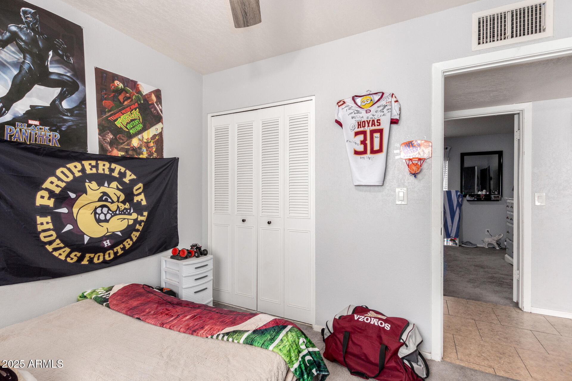 12608 West Lower Buckeye Road Avondale, AZ 85323 - Photo 23 of 26 a bedroom with a bed and painting on the wall