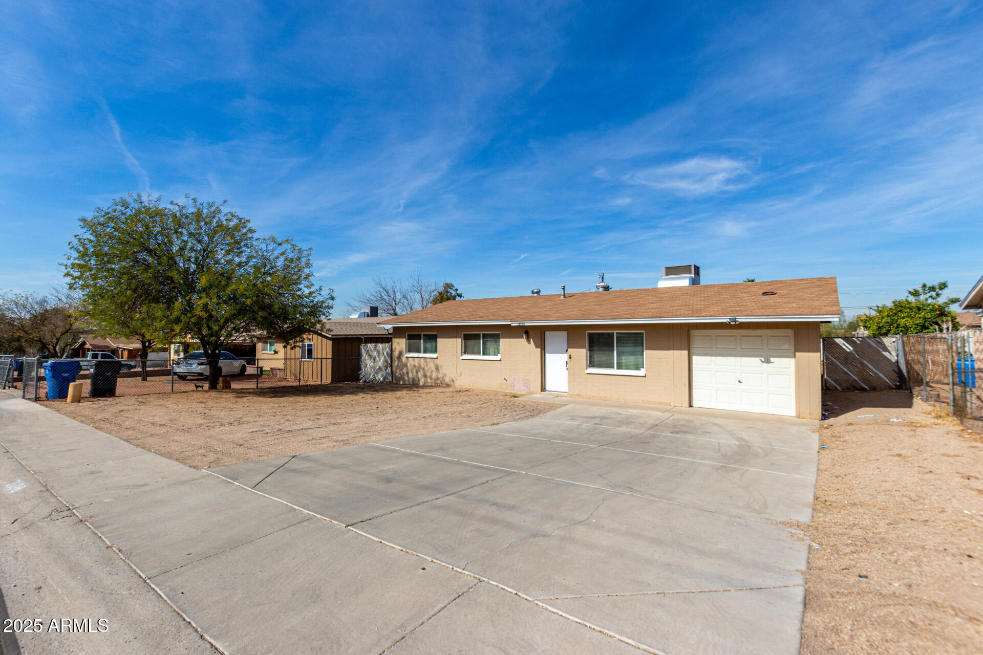 12608 West Lower Buckeye Road Avondale, AZ 85323 - Photo 5 of 26 a front view of a house with a yard and garage