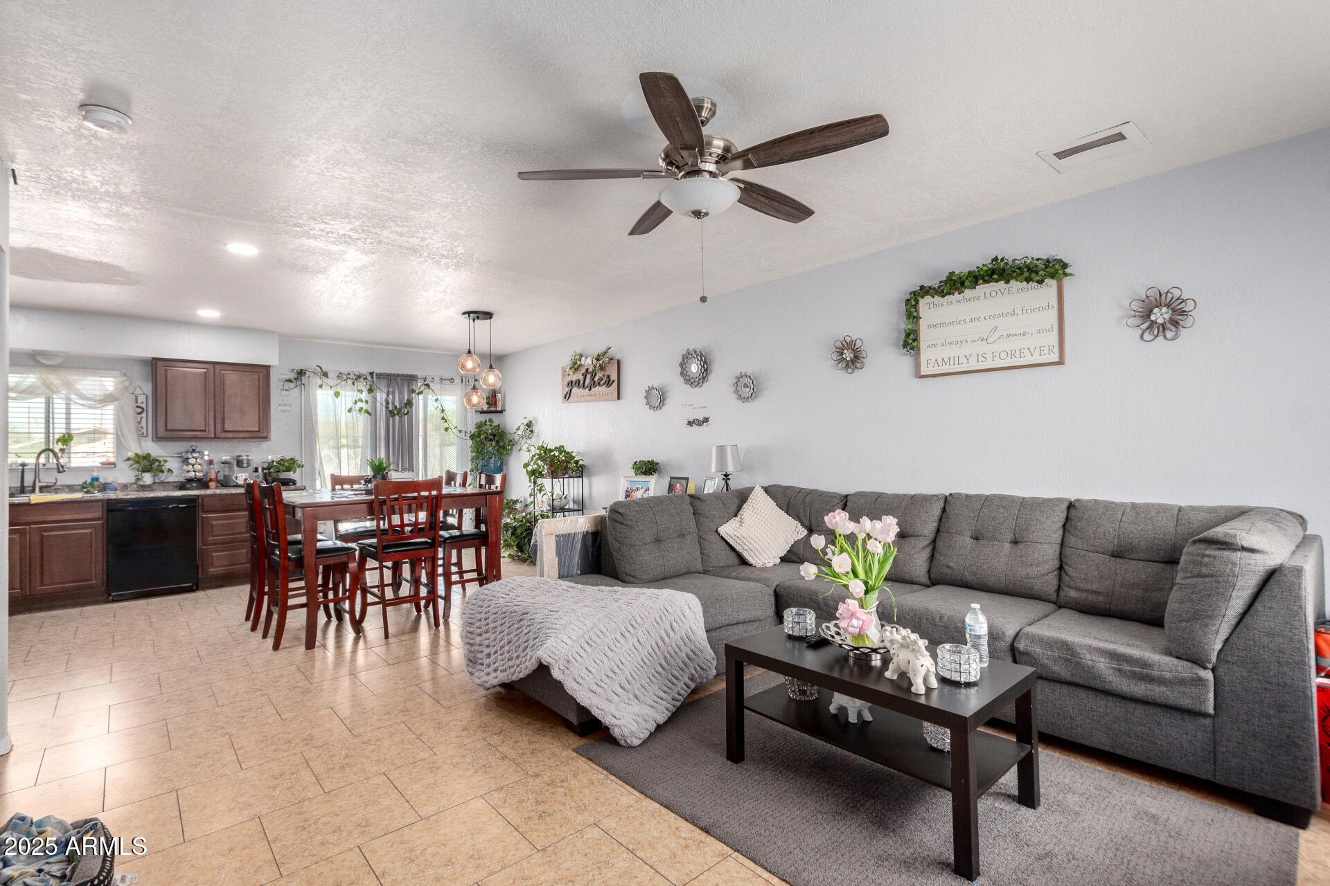 12608 West Lower Buckeye Road Avondale, AZ 85323 - Photo 7 of 26 a living room with furniture and kitchen view