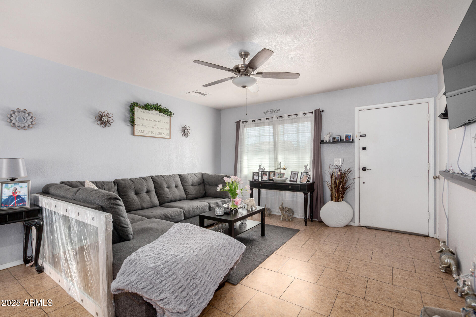 12608 West Lower Buckeye Road Avondale, AZ 85323 - Photo 8 of 26 a living room with furniture and a large window