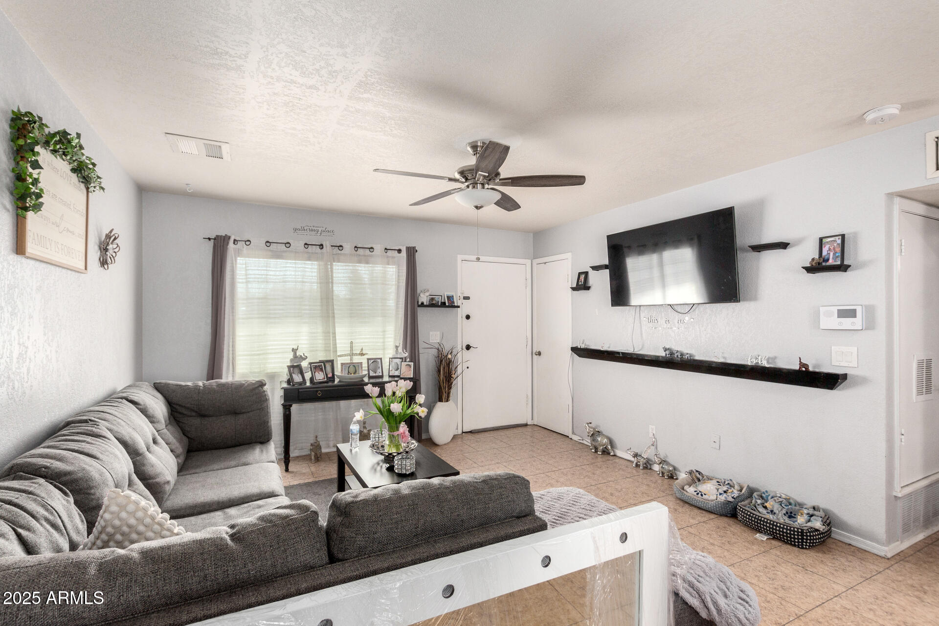 12608 West Lower Buckeye Road Avondale, AZ 85323 - Photo 9 of 26 a living room with furniture and a large window