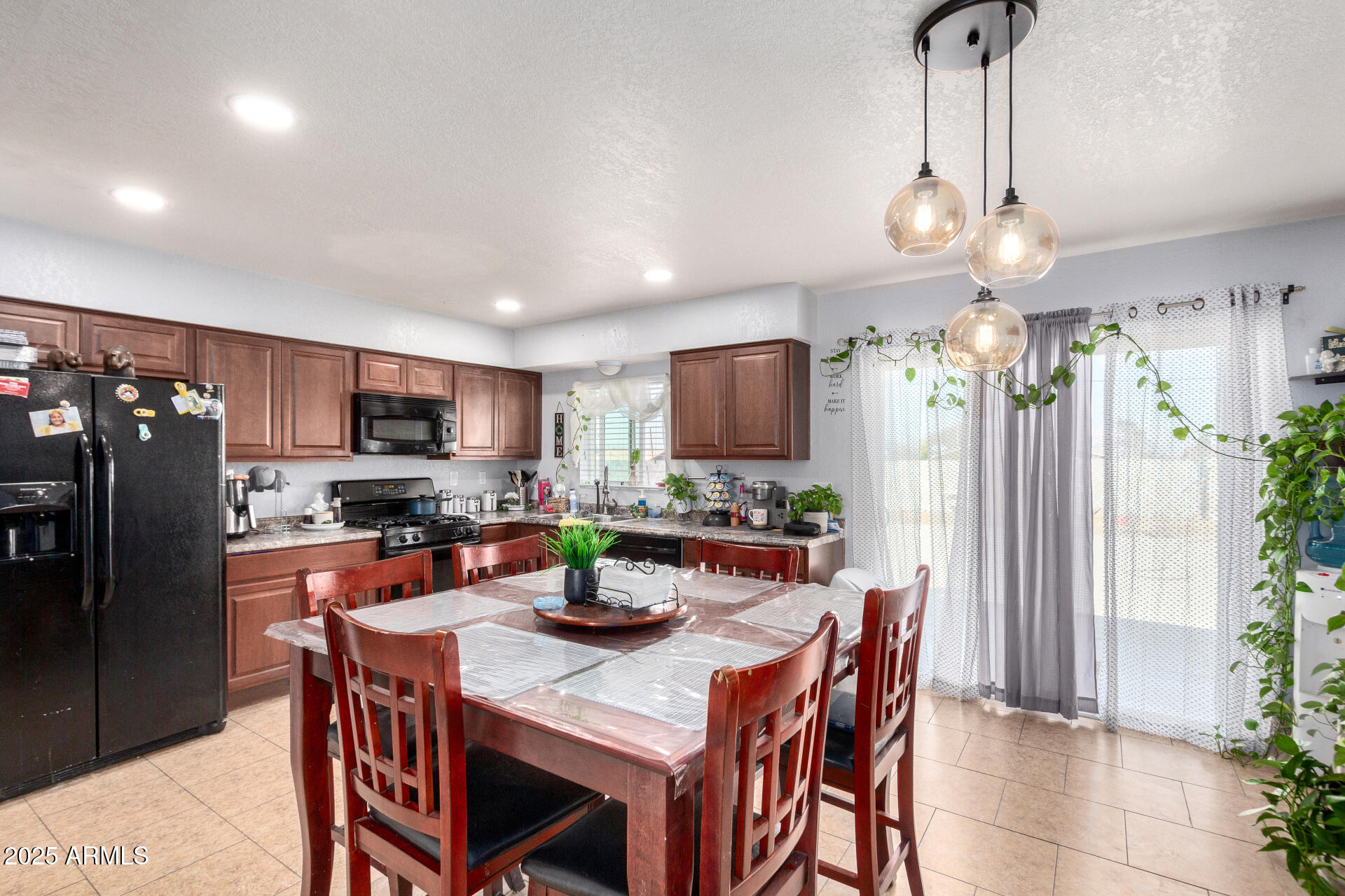 12608 West Lower Buckeye Road Avondale, AZ 85323 - Photo 10 of 26 a kitchen with a dining table and chairs