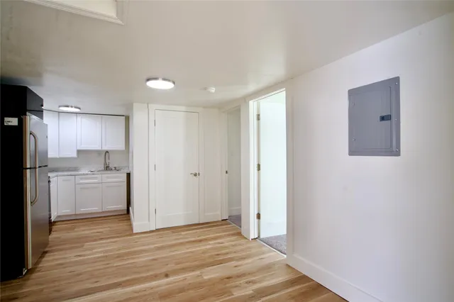 a view of a kitchen with a sink and a refrigerator