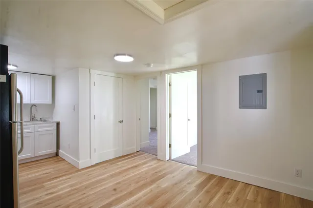 a view of a kitchen with a sink and a refrigerator