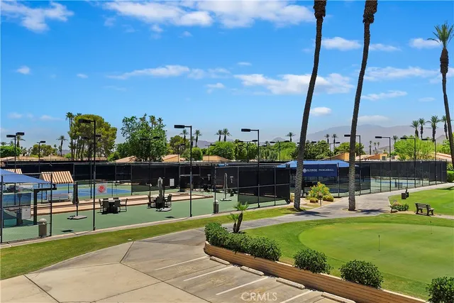 a view of a swimming pool with a lawn chairs and a yard