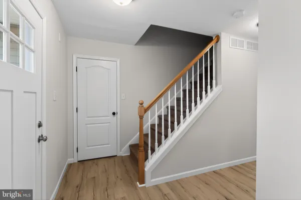 a view of an entryway with wooden floor
