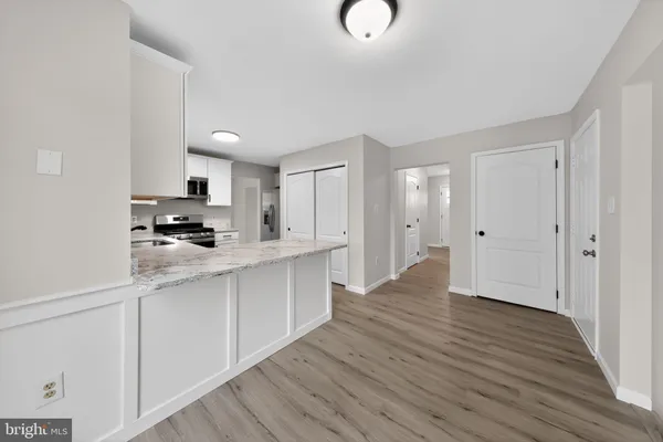 a kitchen with a refrigerator and a stove top oven