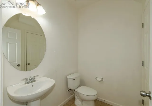 a bathroom with a sink mirror and toilet