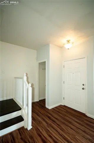 a view of front door with wooden floor