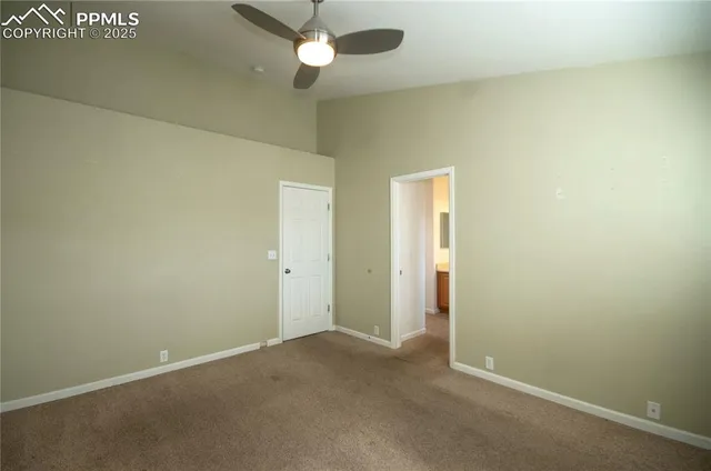 an empty room with a empty space and a ceiling fan