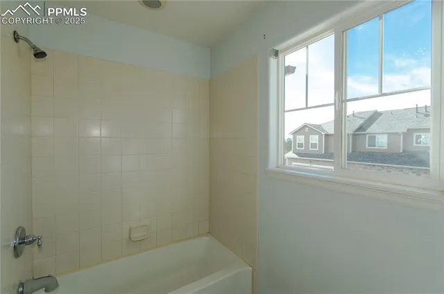 a bath tub sitting next to a window