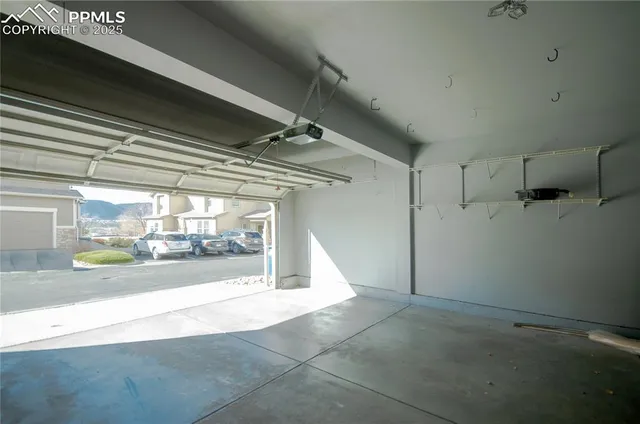 a view of a hallway with a glass door and chandelier