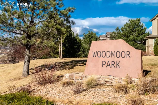 a sign of a park next to a road