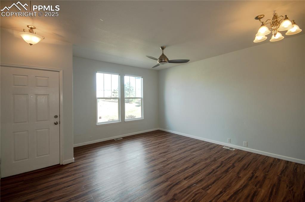 1316 Walters Point Monument, CO 80132 - Photo 4 of 33 wooden floor in an empty room with a window