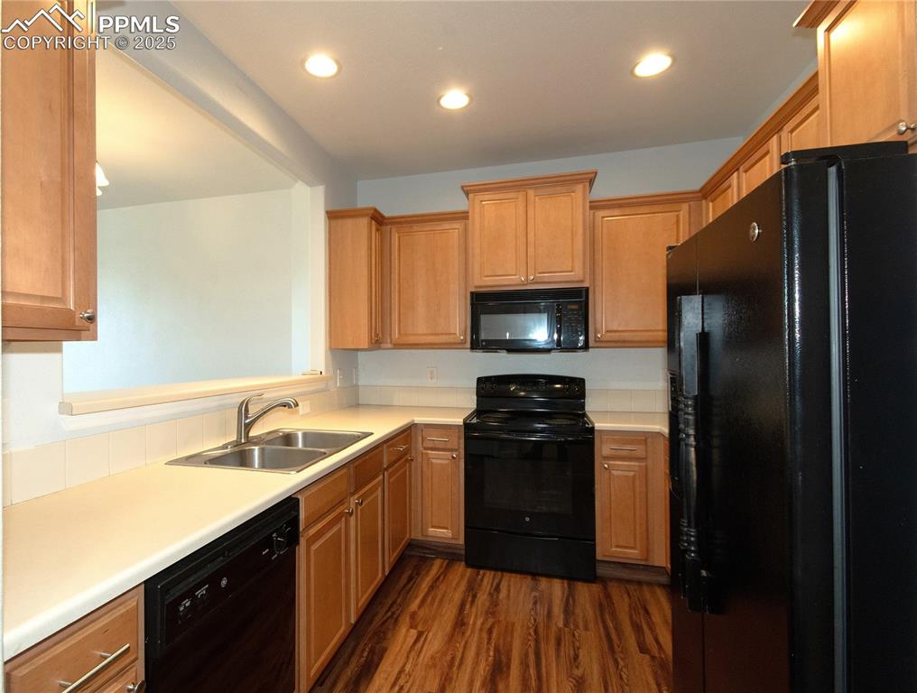 1316 Walters Point Monument, CO 80132 - Photo 7 of 33 a kitchen with a sink stove top oven and refrigerator