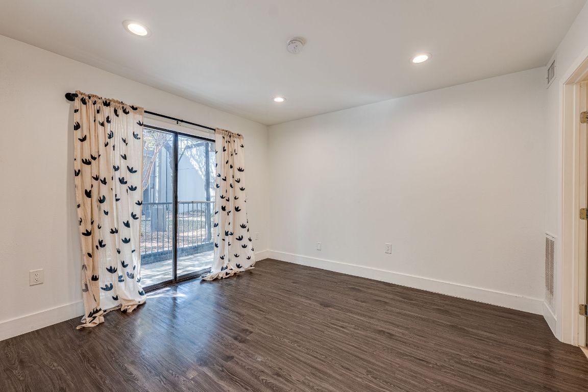 935 La Posada Drive, Unit 156 Austin, TX 78752 - Photo 11 of 40 wooden floor in an empty room with wooden floor