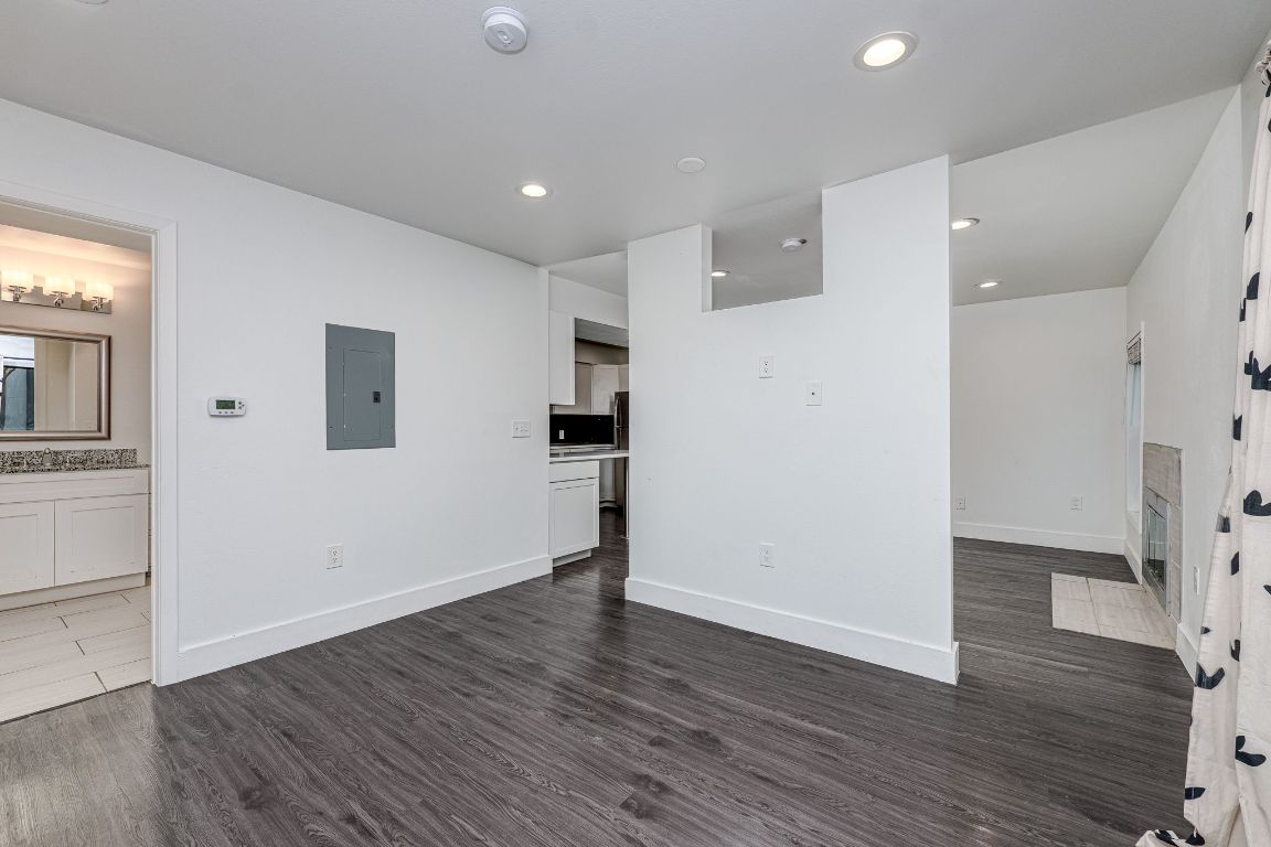 935 La Posada Drive, Unit 156 Austin, TX 78752 - Photo 13 of 40 a view of a kitchen with wooden floor and a refrigerator