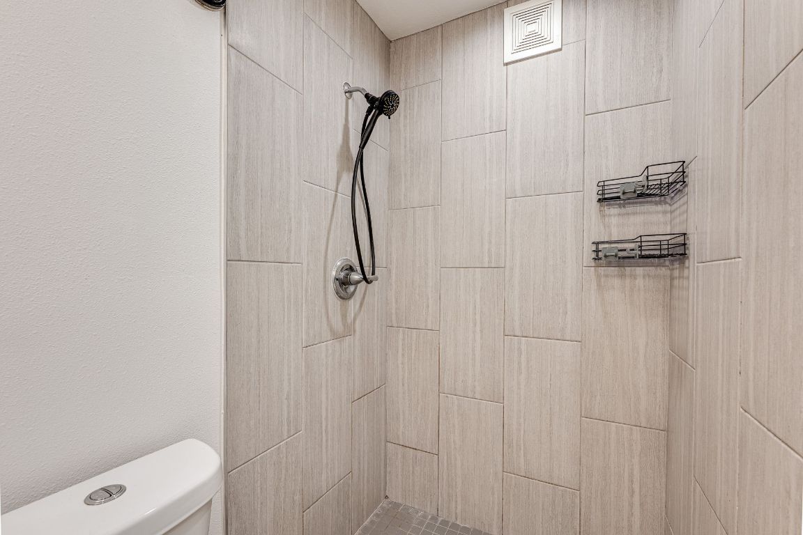 935 La Posada Drive, Unit 156 Austin, TX 78752 - Photo 16 of 40 a bathroom with a shower and toilet