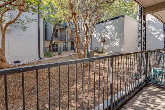 a view of a balcony with wooden fence