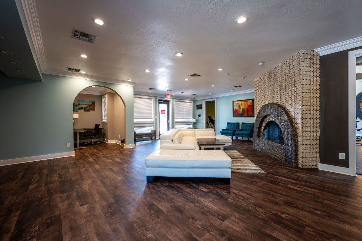 935 La Posada Drive, Unit 156 Austin, TX 78752 - Photo 28 of 40 a living room with furniture and a fireplace