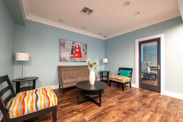 a living room with furniture and a lamp