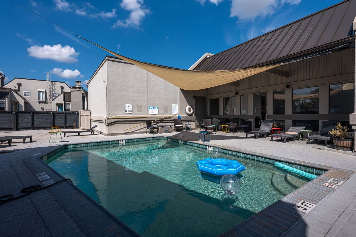 935 La Posada Drive, Unit 156 Austin, TX 78752 - Photo 38 of 40 a view of a swimming pool with outdoor seating and a patio