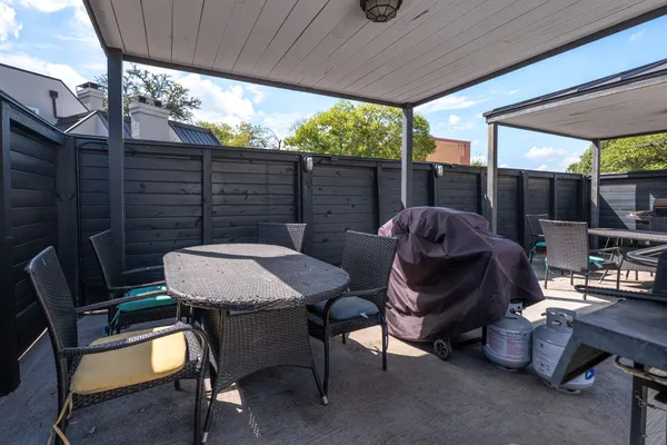 a view of a patio with a table chairs and a backyard