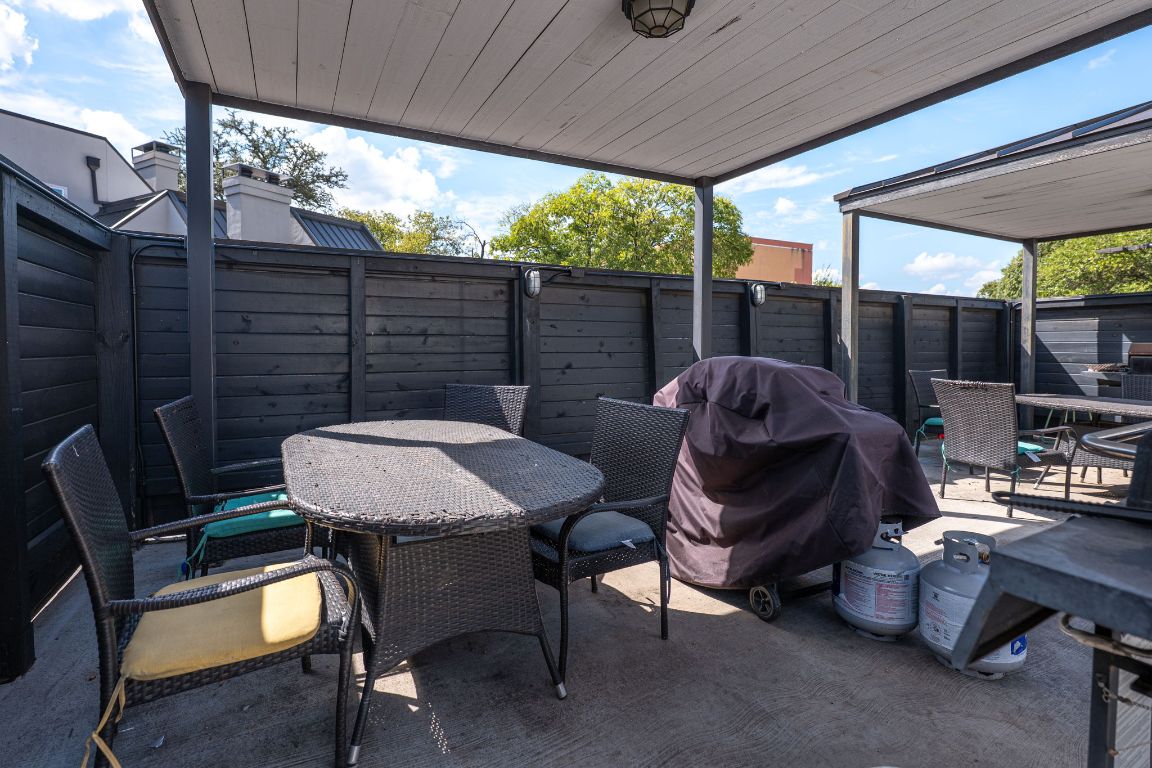 935 La Posada Drive, Unit 156 Austin, TX 78752 - Photo 39 of 40 a view of a patio with a table chairs and a backyard