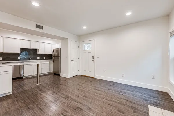 a view of kitchen with wooden floor and electronic appliances