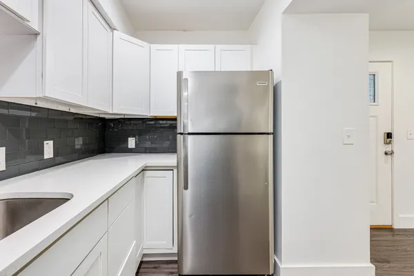 a white refrigerator freezer sitting in a kitchen