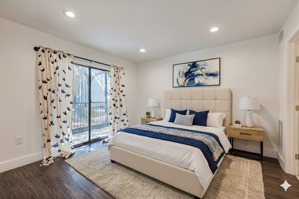 935 La Posada Drive, Unit 156 Austin, TX 78752 - Photo 10 of 40 a spacious bedroom with a bed and a wooden floor